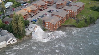 Flooding event of the Mendenhall River causing damage to infrastructure.