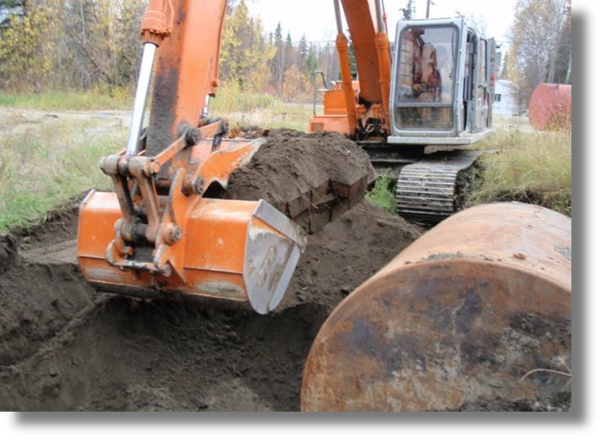 backhoe digging up dirt at Brownfield site